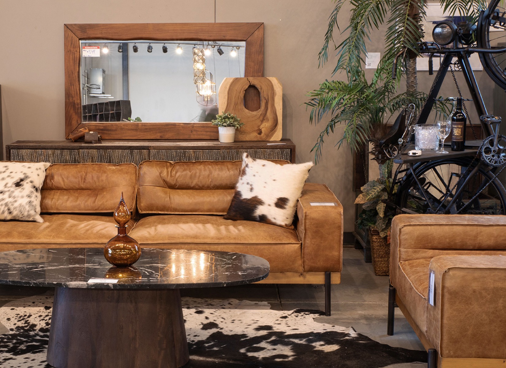 HTD Home Trends Design Austin Showroom featuring the round Mountain Lodge Dining Table and Mindy Dining Chairs in Asphalt Velvet fabric.